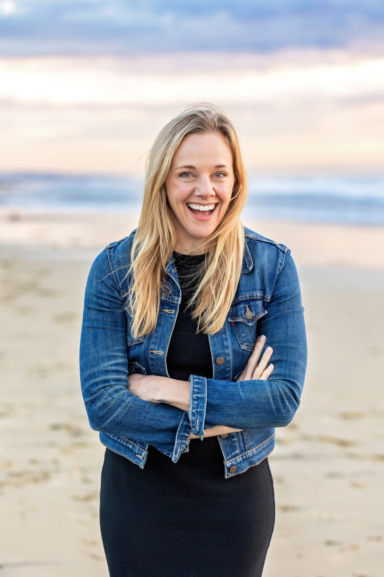 Susan Sjolund, ICF-accredited leadership and life coach, laughing on the beach